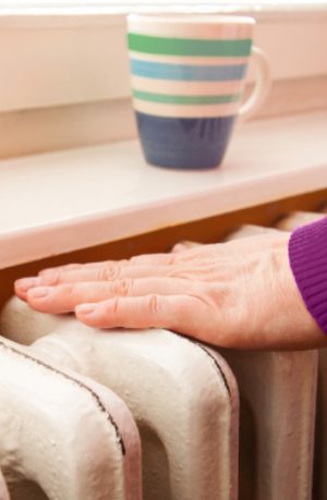 Hand touching radiator